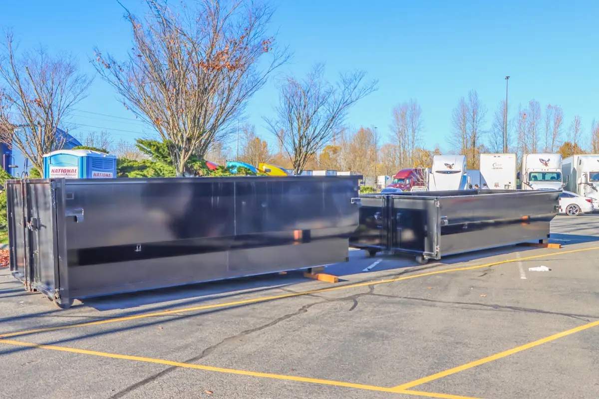 Professional dumpster rental service with roll-off container on residential driveway in Crestline